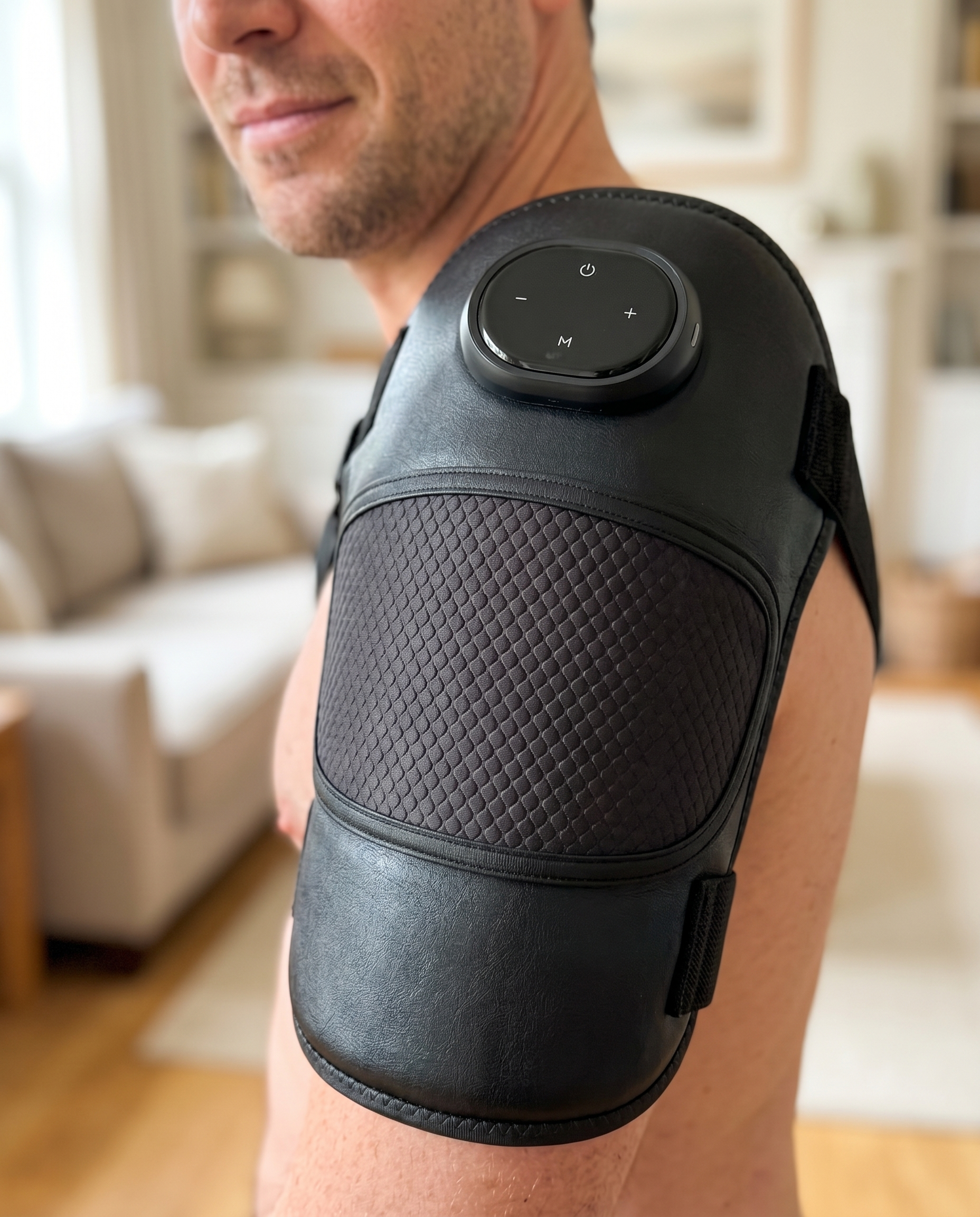 Man using black heated massager wrap on his shoulder, 3-in-1 use