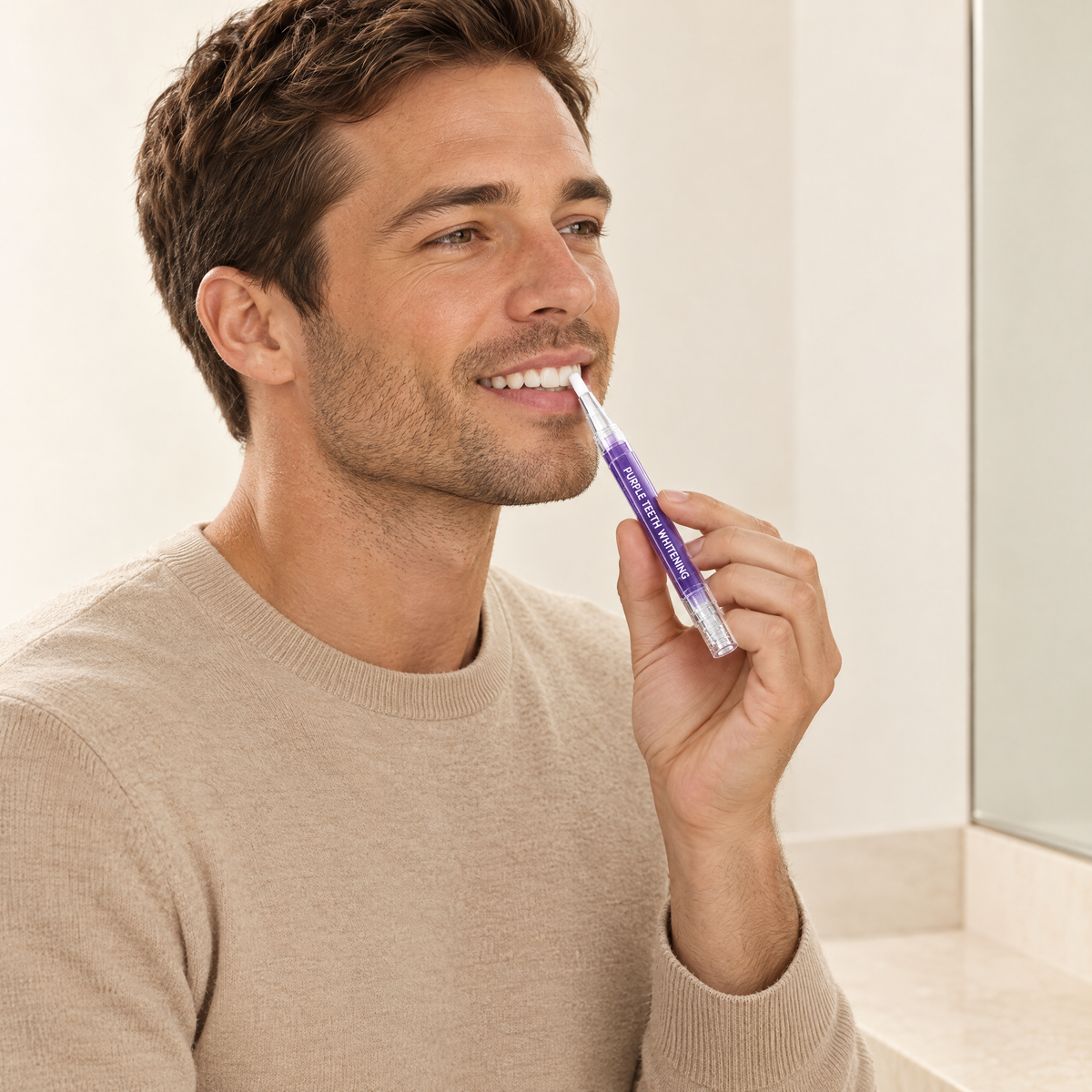 Man applying the purple whitening pen to his teeth